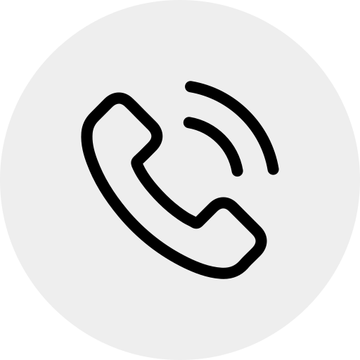 Black phone receiver icon with two curved lines indicating sound or ringing, centered on a light gray circular background.